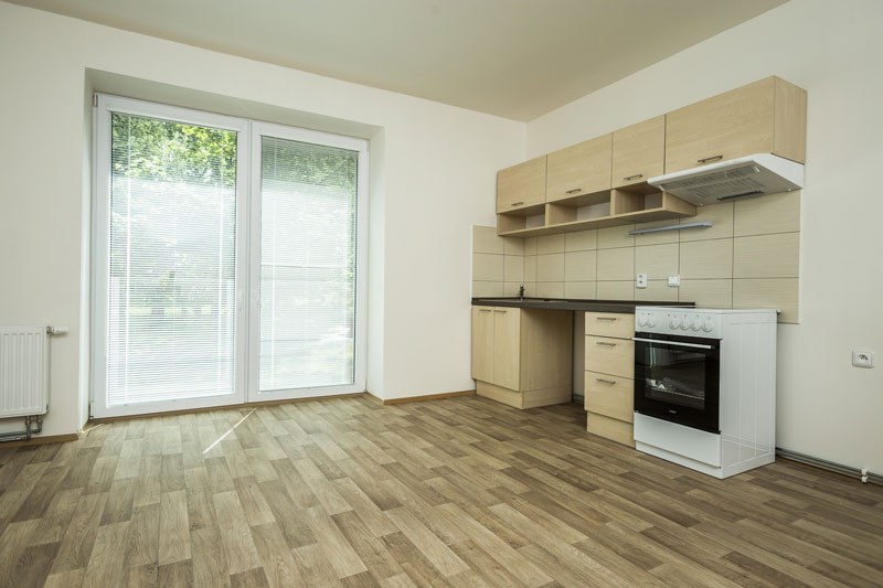 Kuchyně s vestavěnou linkou a sporákem září novotou.